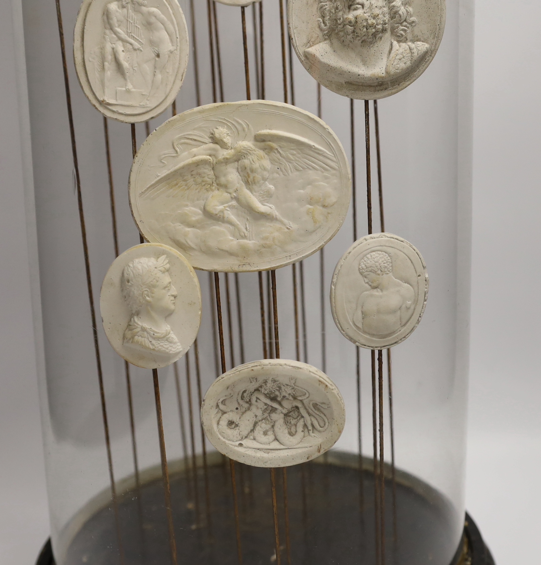 Twenty two Grand Tour intaglio reliefs, under glass dome, height 63cm.